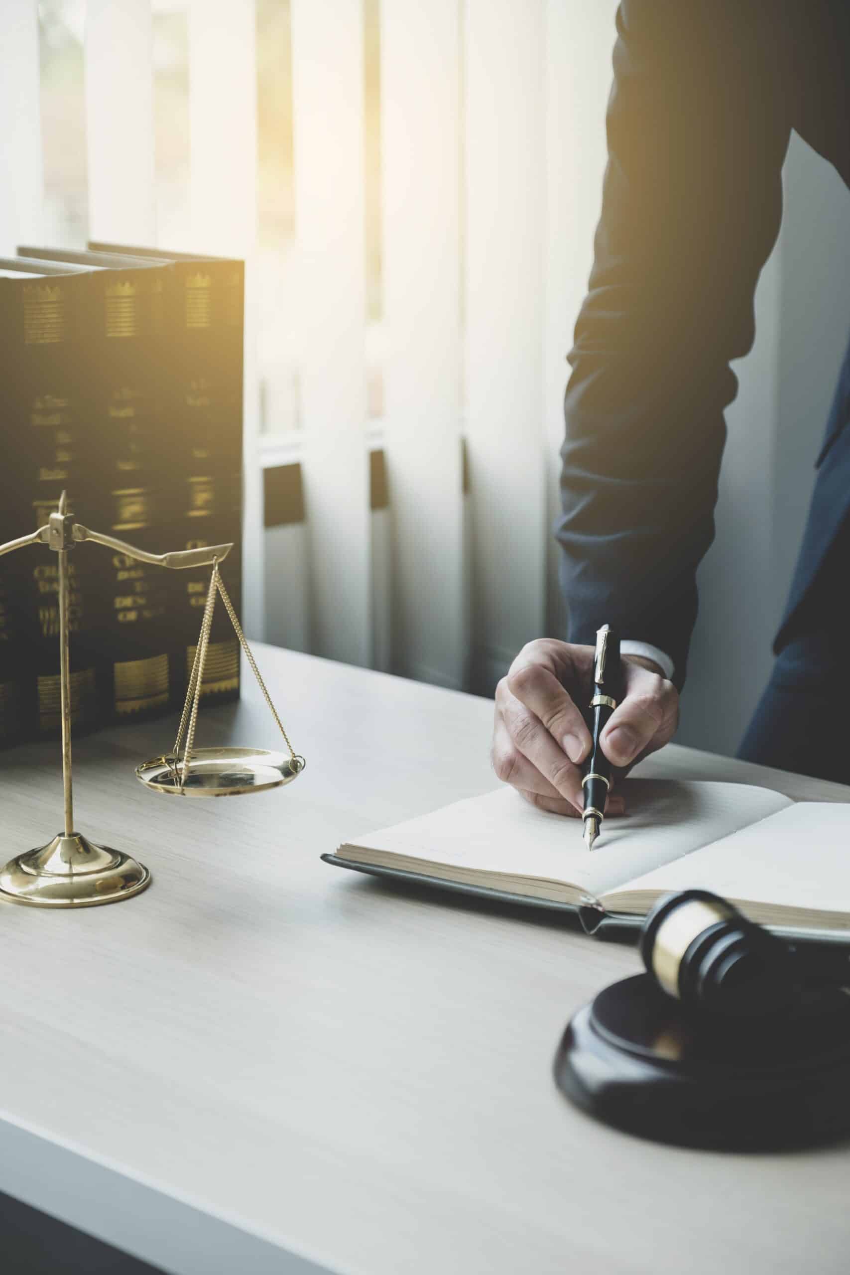 lawyer hand holding pen and writing something