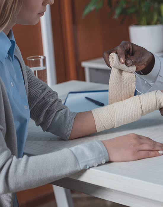 doctor bandaging woman who got burns